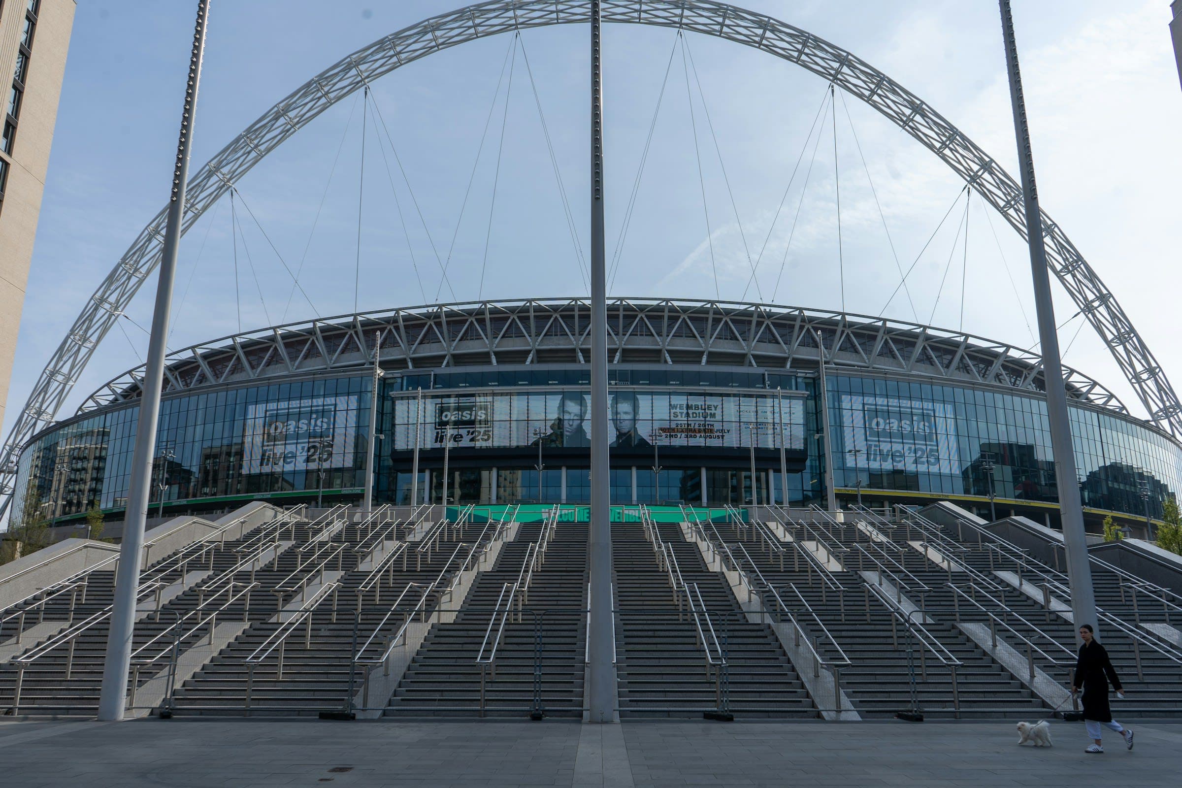 Wembley Stadium in London with its white arch under a clear blue sky